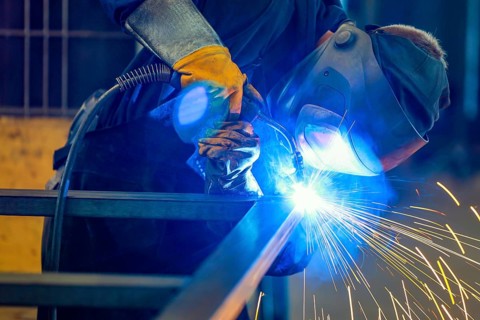 Germany - Theme photo metal industry. An industrial welder welds a workpiece