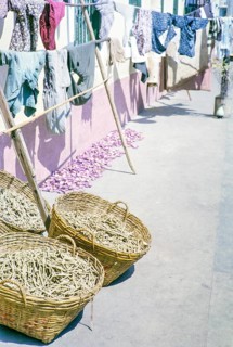 Clothes handing out to dry with baskets of what is thought to be clothes pegs, clothespins, Macau,