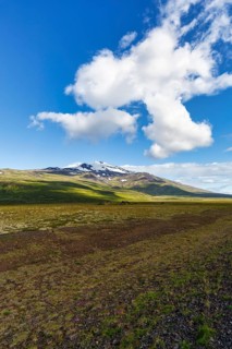 Barren volcanic landscape with a view of the snow-covered Snæfellsjökull volcano, Snäfellsjökull,