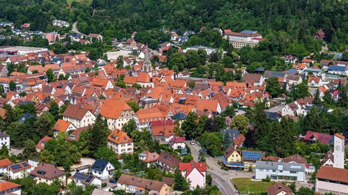 Town view of Münsingen on the Swabian Alb with town hall and church. Drone photo. Town centre of