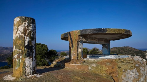 Concrete bunker with round platform high on a hill under a clear sky, Lost Place, Lago