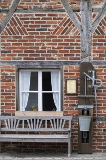 Half-timbered house, half-timbered façade with bench and swing pump, Borken-Gemen Heritage House,