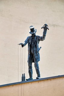 Bronze figure of puppeteer on the roof by artist Roland Lindner, Zeitz, Saxony-Anhalt, Germany