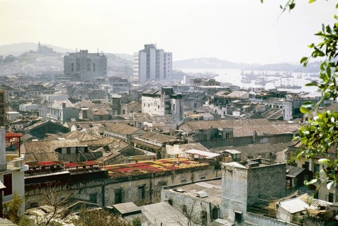 View over rooftops of high density buildings in city centre to Our Lady of Penha Chapel on hilltop