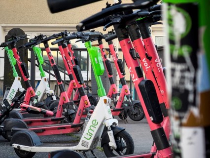 Many rental e-scooters parked on a pavement in Wuppertal, Germany