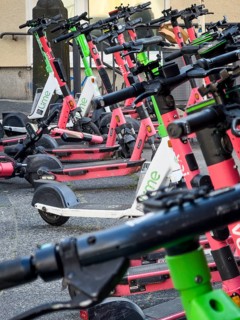 Many rental e-scooters parked on a pavement in Wuppertal, Germany
