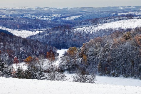 Snow-covered hills with forests, a wintery and quiet landscape stretches far and wide, Siegen