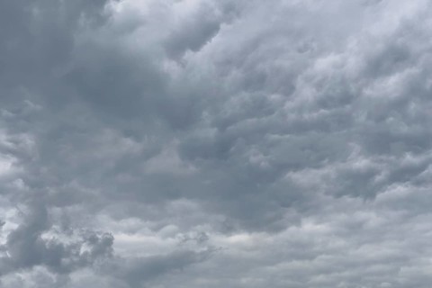 A gathering rain front of grey clouds forms a closed cloud cover, international