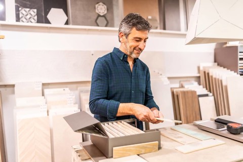 Architect selecting ceramic tile samples in a home improvement store for a new bathroom or kitchen