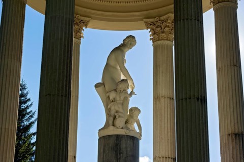 Statue of Venus with Cupid in the Temple of Venus above the terraced gardens, backlight, blue sky,