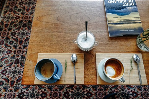 Two cups of coffee, cappuccino, coffee speciality, table decoration in a café, view from above,