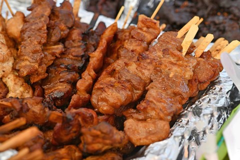 Grilled pork barbecue at Thai street food festival. Traditional Thai skewers being served at