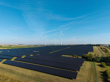 Renewable energy sources with solar and wind systems on an extensive field, near Kitzingen, Lower