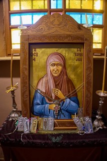 Icon of Panagia Kyra, Religious icon on an altar with candles and decorative details in an