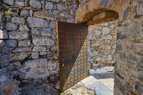 Rustic wooden gate in a stone-lined ruin, historical atmosphere, Pandeli Castle, castle, Leros