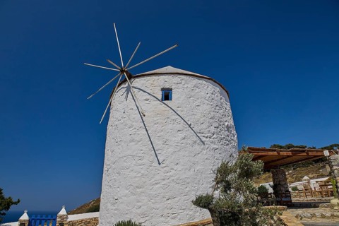 Single white windmill with large propeller under clear blue sky, Pandeli Castle, Castle, Leros