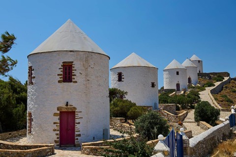 White windmills with red doors under a clear blue sky on a Greek island, Pandeli Castle, Castle,