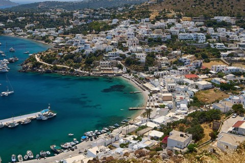 Panoramic view of a Greek coastal town with houses and yachts on the clear blue sea, Pandeli