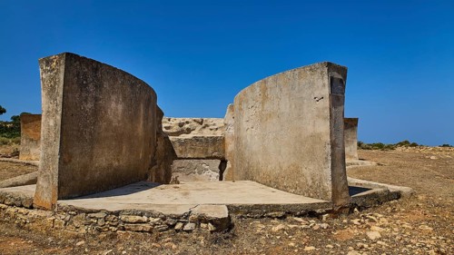 Massive concrete ruin in dry landscape with clear blue sky, Lost Place, Air Defence Position,