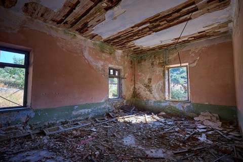 Lost Place, Old room with damaged walls and broken ceiling, rubble and view into nature, Radio