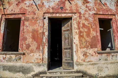 Lost Place, Old façade with open door and peeling plaster, a picture of decay, Radio Station, WW2,