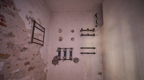 Lost Place, An empty white room with remains of pipes on the walls, electrical installations, Radio