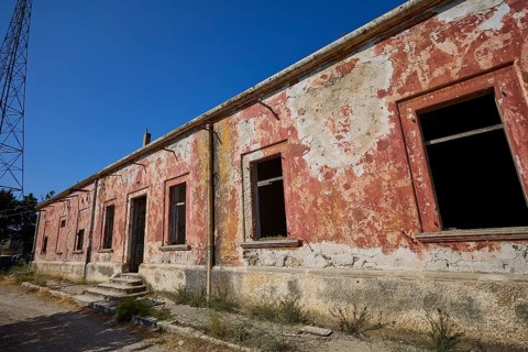 Lost Place, Long abandoned building with peeling red paint and open entrance, Radio Station, WW2,