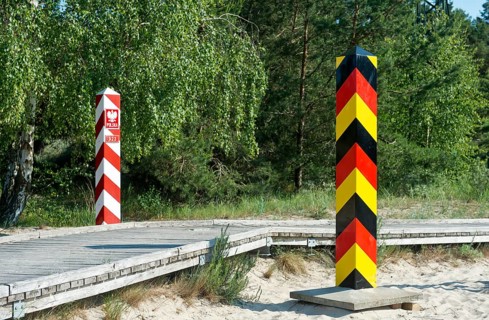Pedestrian and cycle path with German and Polish border posts along the German-Polish border near