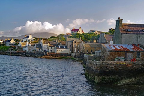 Numerous buildings at a stone harbour under a cloudy sky, Stromness, Mainland, Orkney Islands,