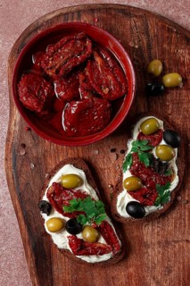 Sandwich with cream cheese, dried tomatoes, olives, breakfast, top view