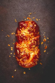 Braided, sweet bread pie, with sliced almonds, breakfast, braided bread, brioche, on a dark