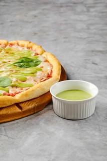 This dish features a freshly baked pizza with a golden crust adorned with toppings like fresh