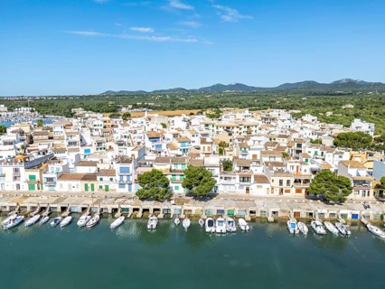 Portocolom fishing village on Majorca aerial view from above with boats holiday by the sea trip in