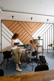 Two women discussing their a startup in the field of women's health in a contemporary office
