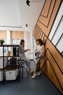 Two women stayed up late discussing their app for monitoring women's health in a startup office