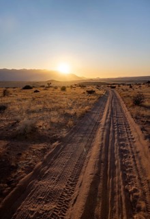 Sandy track, desert landscape in the evening light at sunset, backlit, Brandberg, Erongo,