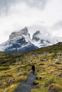 Hikers on a hiking trail to the Mirador de los Cuernos, Cuernos del Paine mountain range in autumn,