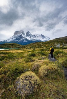 Hikers on the way to the Mirador de los Cuernos, Cuernos del Paine mountain range, dramatic sky,
