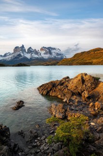 Shore of the blue lake Lago Pehoe in the evening light, Cuernos del Paine mountain range, Torres