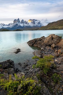 Cuernos del Paine mountain range at sunset, shore of the blue lake Lago Pehoe, Torres del Paine