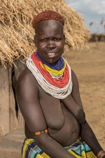 Woman of the Nyangatom ethnic group, also called Bume, with colourful bead necklaces and the