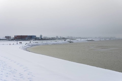Winter day, onset of winter, snow on the North Sea coast, snow-covered beach promenade of