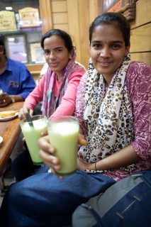 Indian woman drinking lassi or yoghurt drinks in a shop at Sandar Market Girdikot, old town of