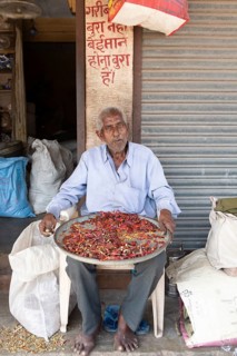 Indian man with chillies, Sandar Market Girdikot, old town of Jodhpur, Rajasthan, India