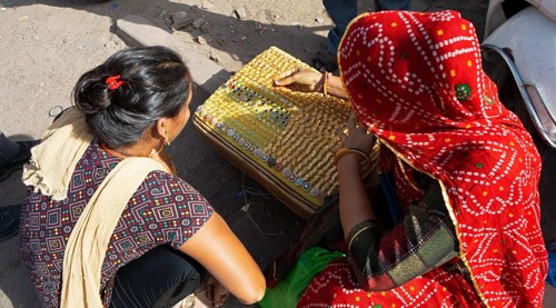 Indian woman bent over jewellery, Sandar Market Girdikot, old town of Jodhpur, Rajasthan, India