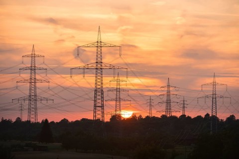 Power lines towering into the evening sky during a sunset, Waiblingen, Baden-Württemberg, Germany