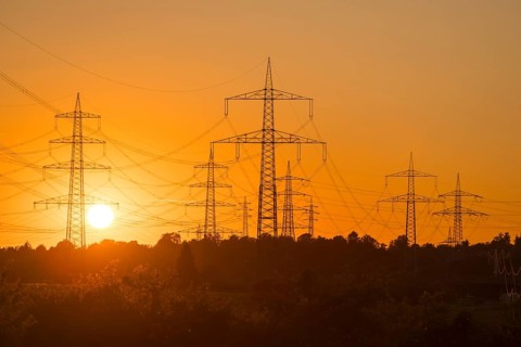 Imposing silhouettes of electricity pylons in front of an intense sunset, Waiblingen,