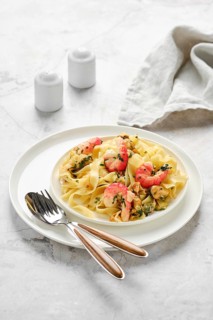 Fettuccine allo Scoglio is elegantly presented on a white plate, featuring fresh seafood like