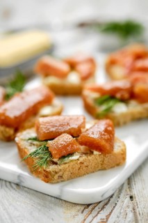 Close-up view of exquisite open-faced sandwiches with herring caviar on a slice of bread, garnished