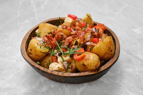 Perfectly cooked baby potatoes are seasoned with herbs and topped with crispy bacon, fresh